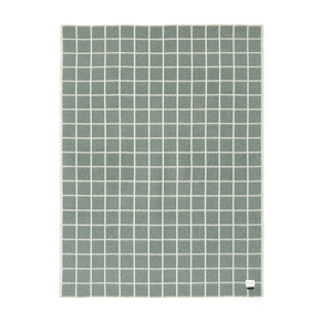 Green square patterned blanket on a white background