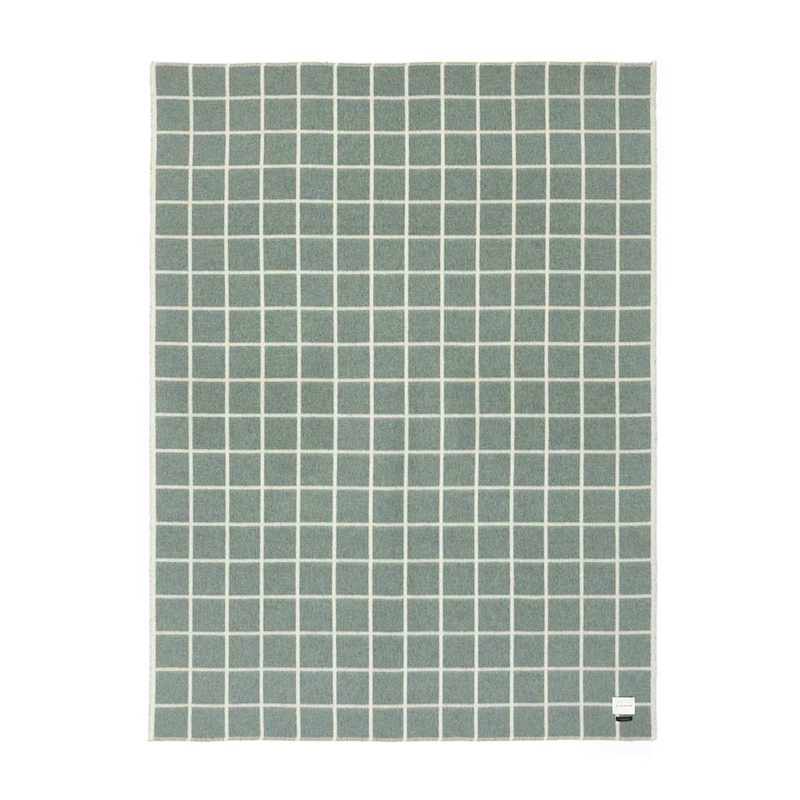 Green square patterned blanket on a white background