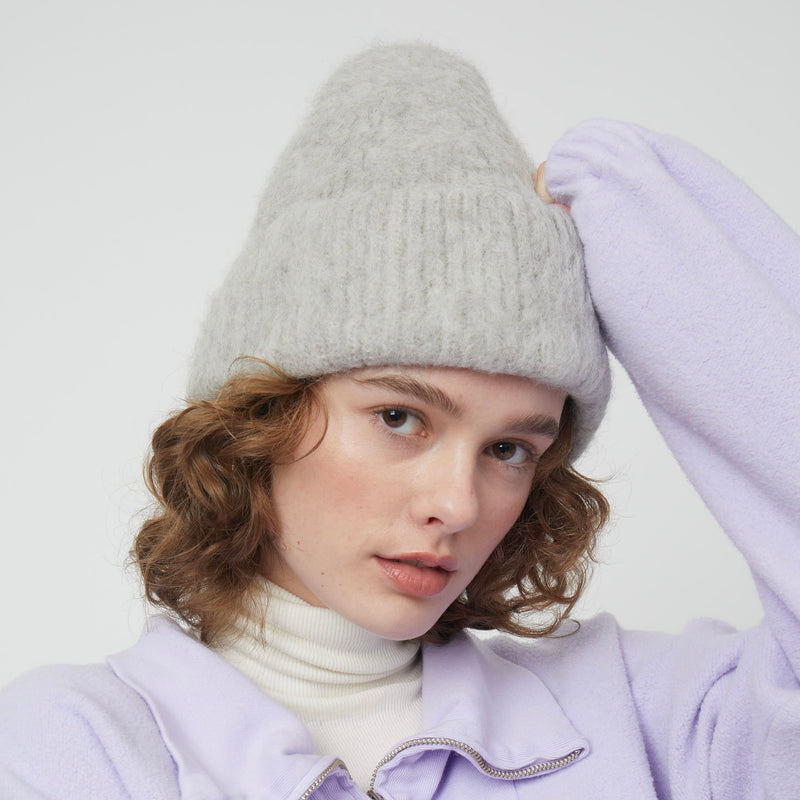 Atelier Delphine Brushed Beanie - model wearing light grey beanie with ribbed cuff on neutral background