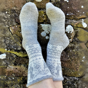 Gray socks worn on a stone surface