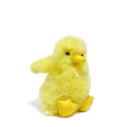 Yellow plush chick toy on a white background