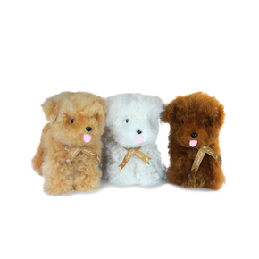 Three plush dogs in brown, white, and brown with a ribbon on a white background