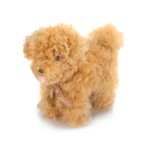 Plush toy dog with a bow on a white background