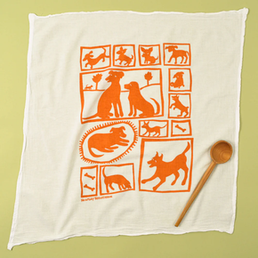 White towel with orange dog illustrations on a green background