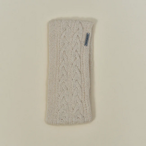 White knitted headband with a brand logo on a beige background