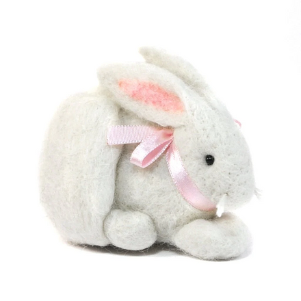 Plush felted bunny toy with a pink bow on a white background