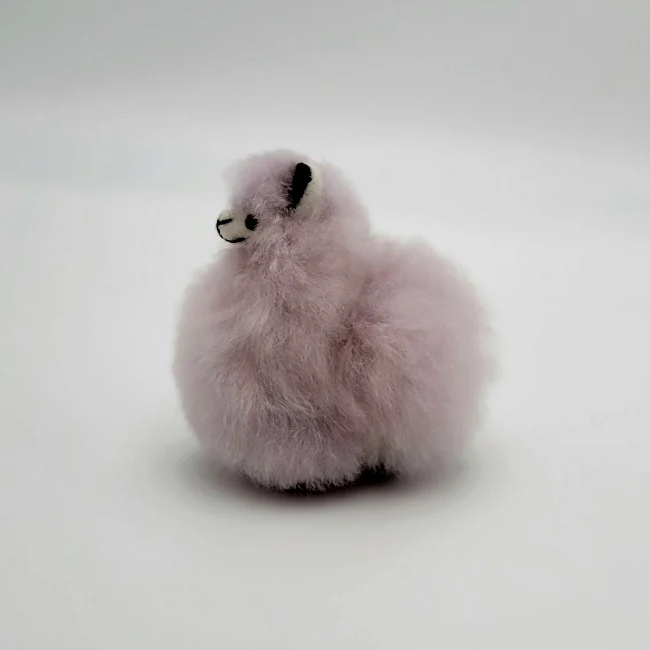 Fluffy purple alpaca keychain on a white background