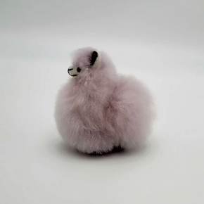 Fluffy purple alpaca keychain on a white background