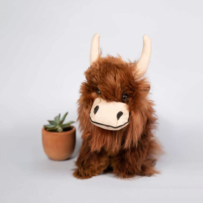 Alpaca fur Highland cow plush on a neutral background