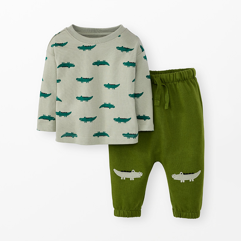 Green baby set with alligator print long-sleeved top and sweatpants with alligator appliqués on the knees.