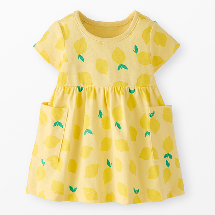 A yellow dress with a bright lemon pattern against a neutral background.