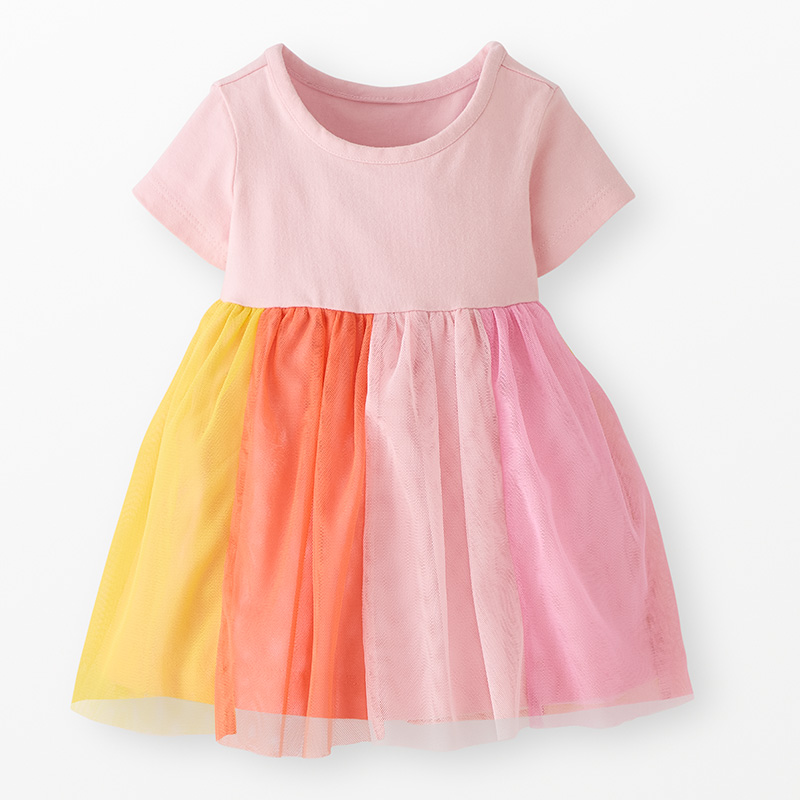 Dress with a pink short sleeve top and sunset rainbow tulle skirt on a neutral background.
