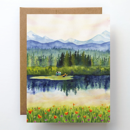 Greeting card with a scenic illustration of a lake, mountains, and trees.