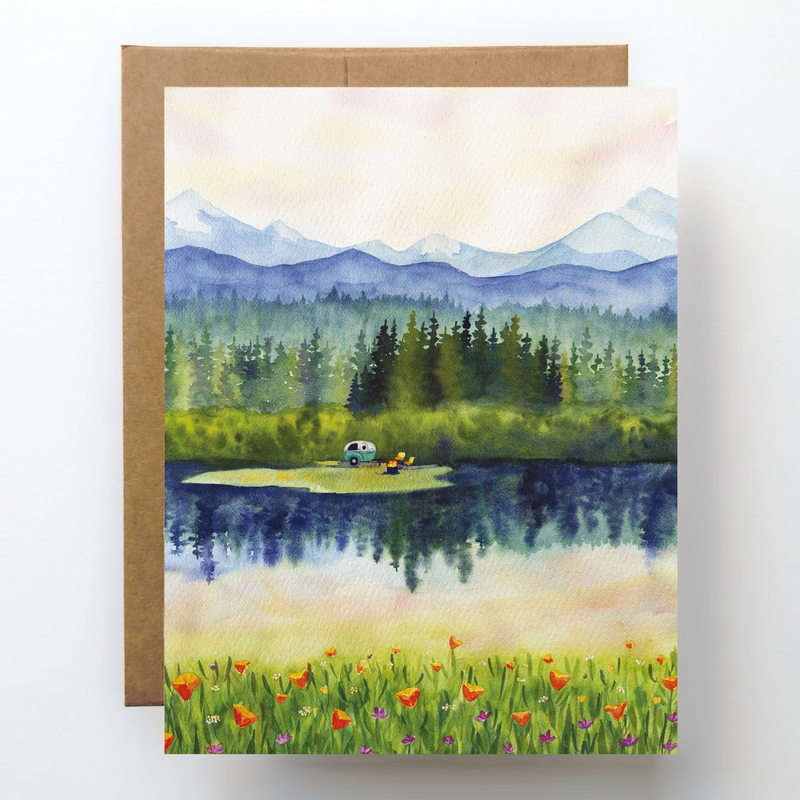 Greeting card with a scenic illustration of a lake, mountains, and trees.
