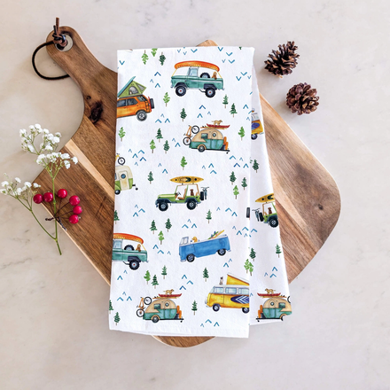 Cotton towel with camping vehicle pattern on a wooden board