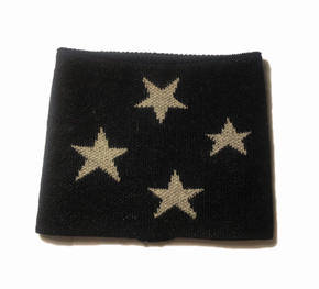 Black neck warmer with grey stars on a white background