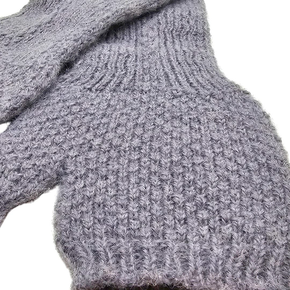 Close-up of a gray knitted fingerless glove on a white background