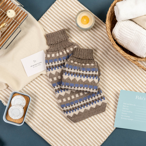 Blue and Beige geometric patterned dog sweaters on spa table