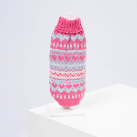 A pink and blue alpaca sweater with a geometric pattern displayed on a mannequin.