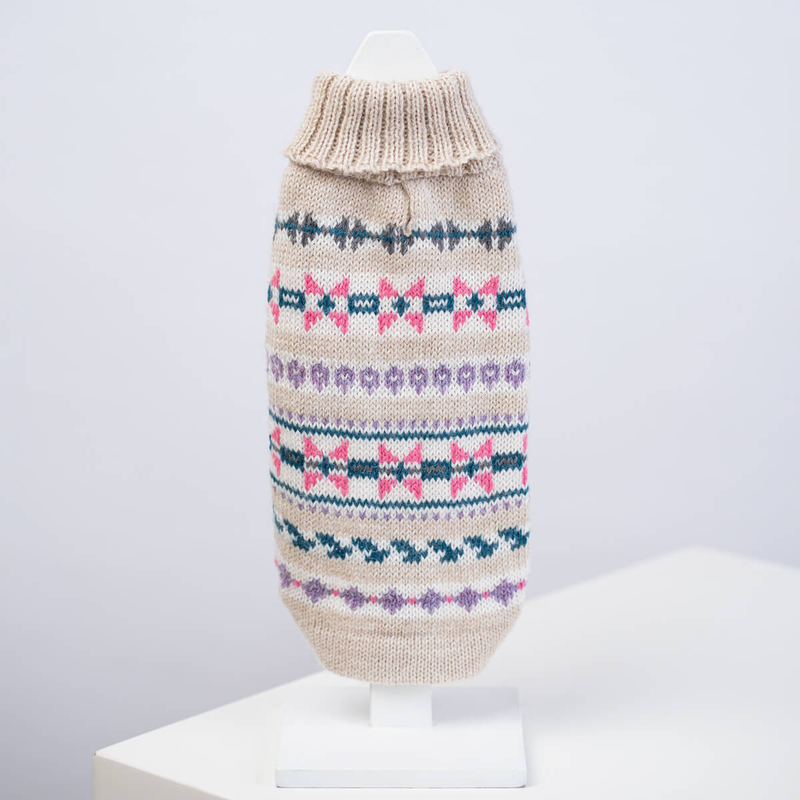 White dog sweater with geometric patten on a white background