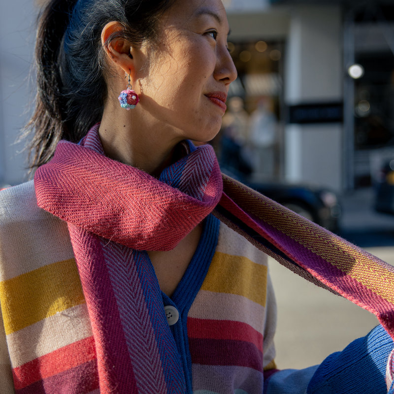 Woman wearing a colorful scarf in an urban setting