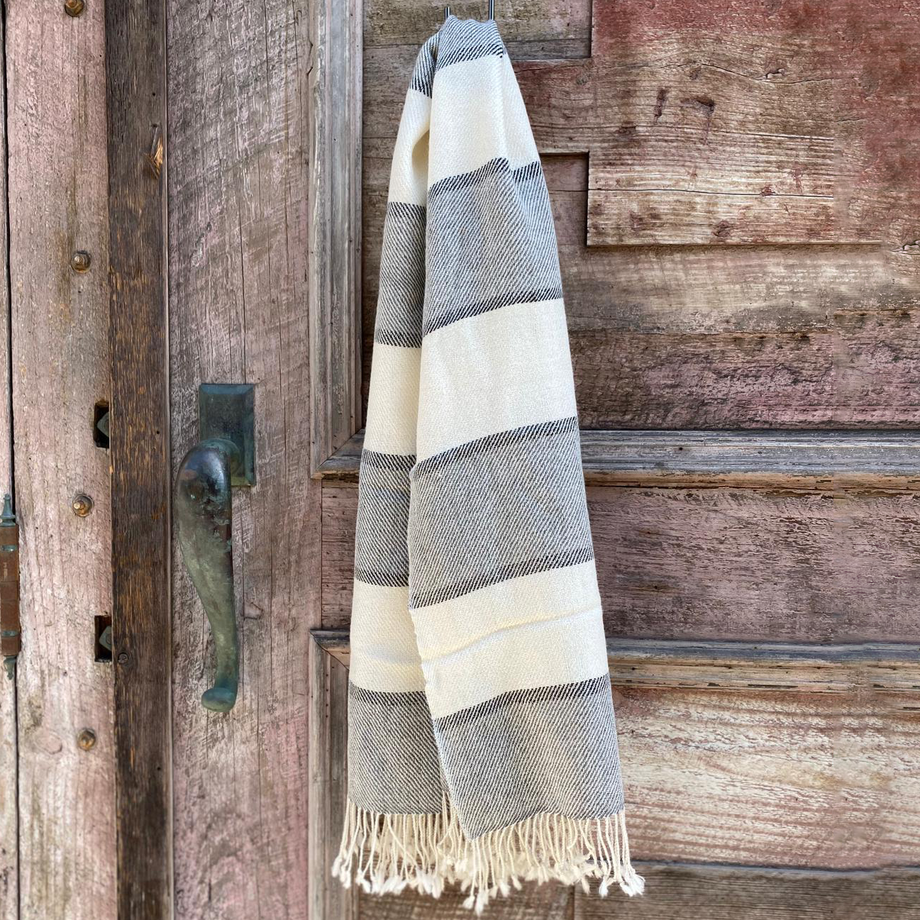 Striped shawl hanging on a wooden door