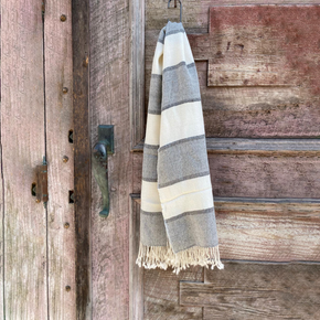 Striped shawl hanging on a wooden door
