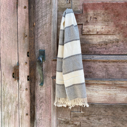 Striped shawl hanging on a wooden door