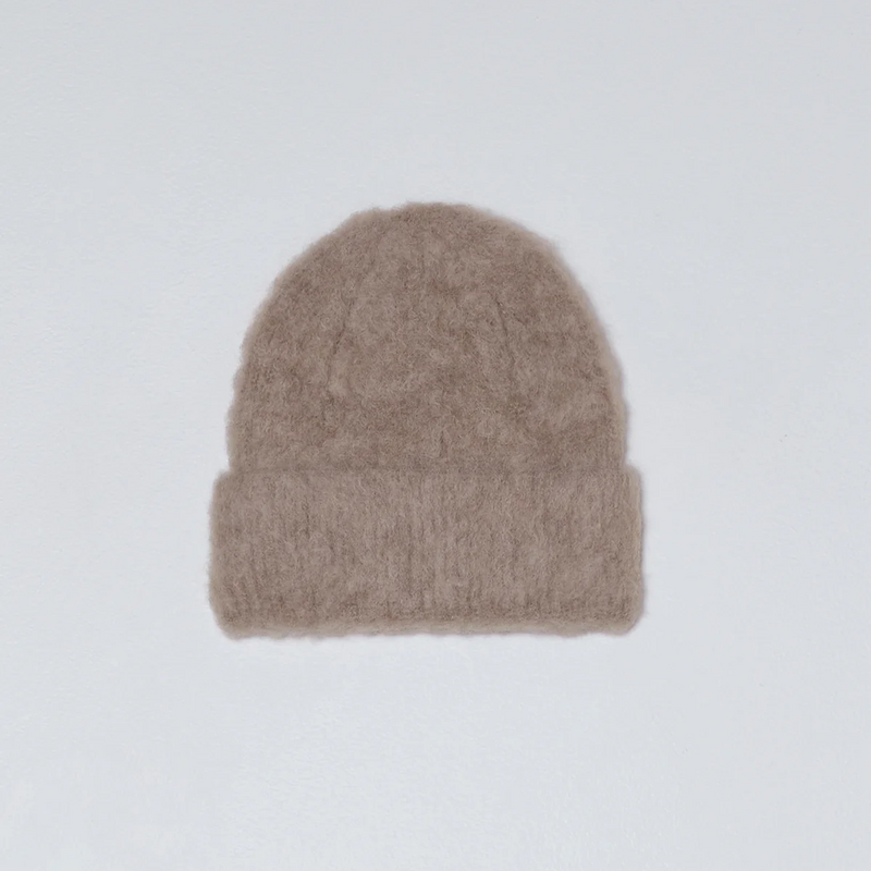 Beige knit beanie on a light gray background