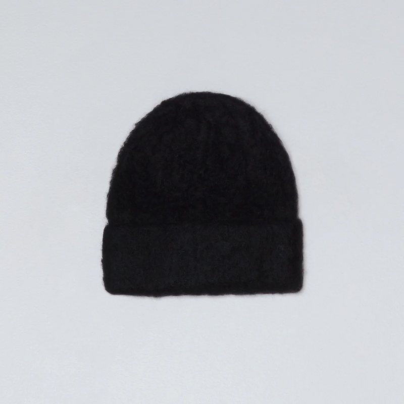Black knit beanie on a light gray background