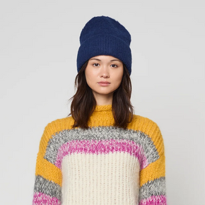 Person wearing a colorful sweater with a white background