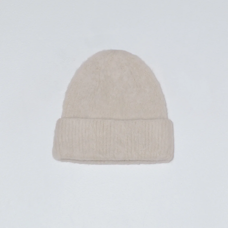 White knit beanie on a white background