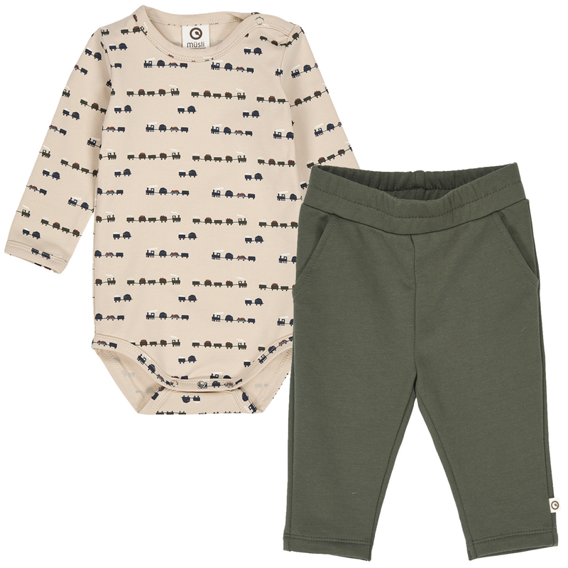 Beige baby bodysuit with train patterns and green pants on a white background