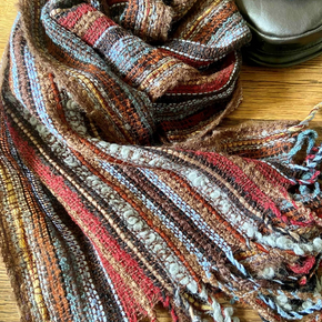 Multicolored striped scarf on a wooden surface