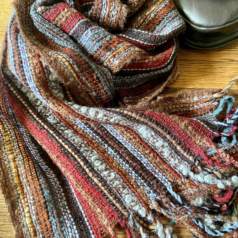 Multicolored striped scarf on a wooden surface