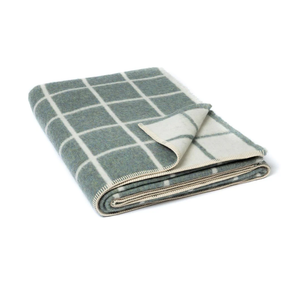 Folded checkered blanket with green and white pattern on a white background