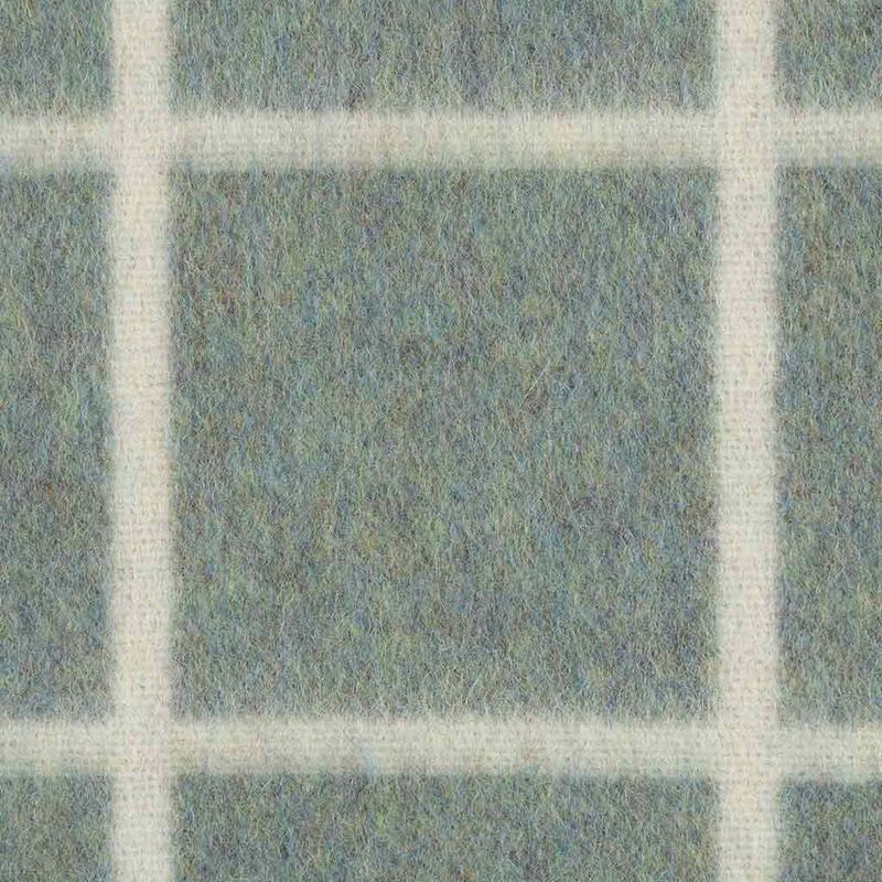 Textured blanket with a grid pattern in shades of green and white