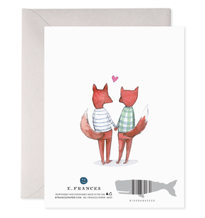 Illustration of two foxes holding hands with a heart above, framed by E. Frances Paper.