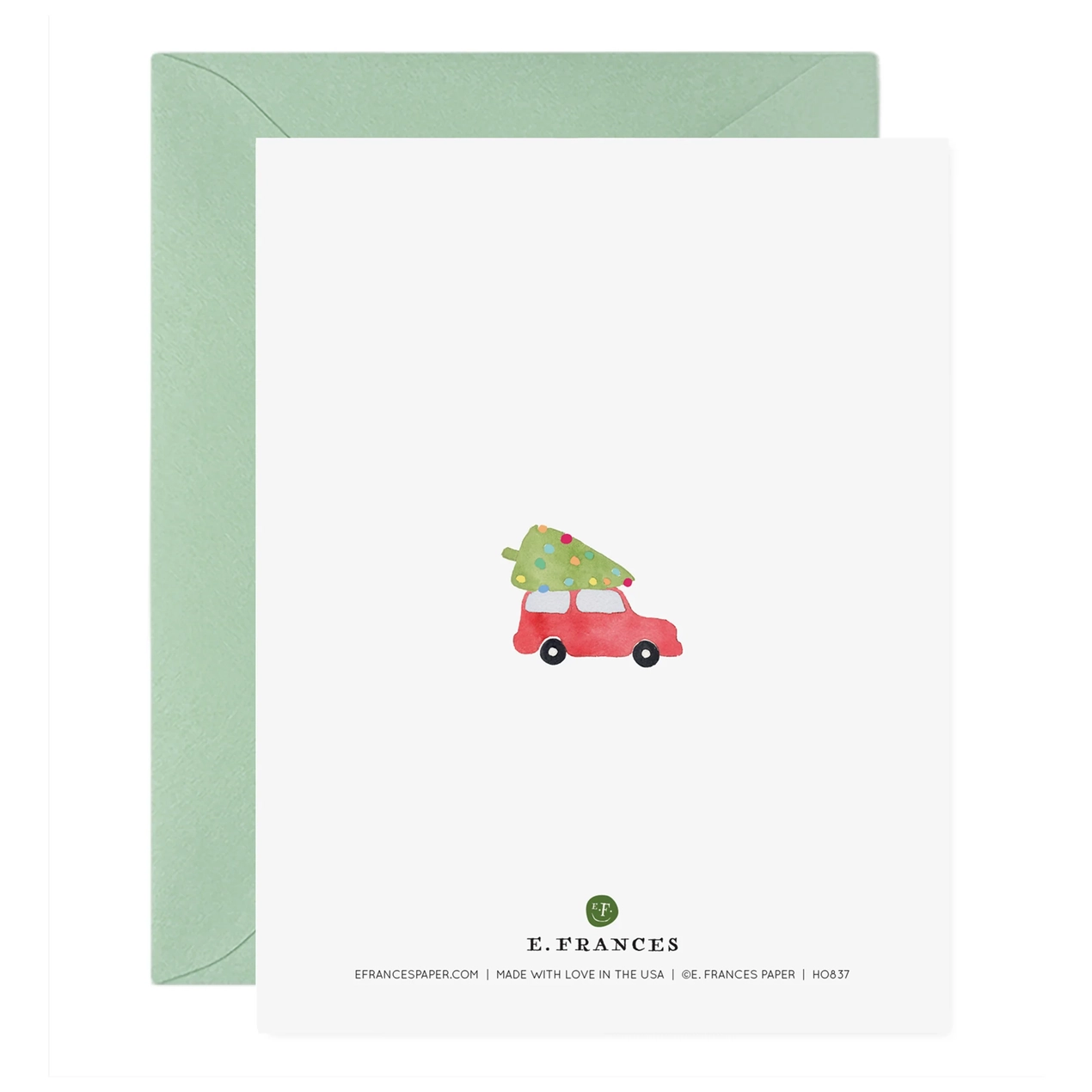 Greeting card with a red car carrying a Christmas tree and green envelope on a white background