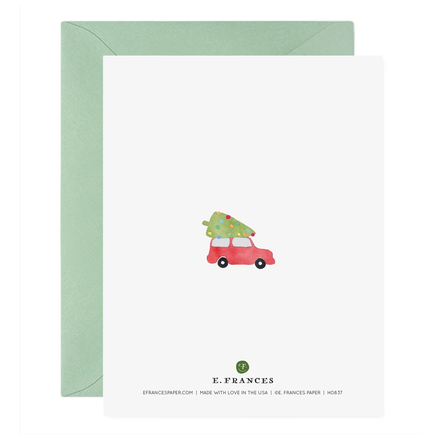 Greeting card with a red car carrying a Christmas tree and green envelope on a white background