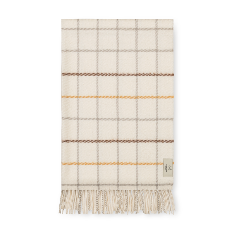 Plaid blanket with fringes on a white background