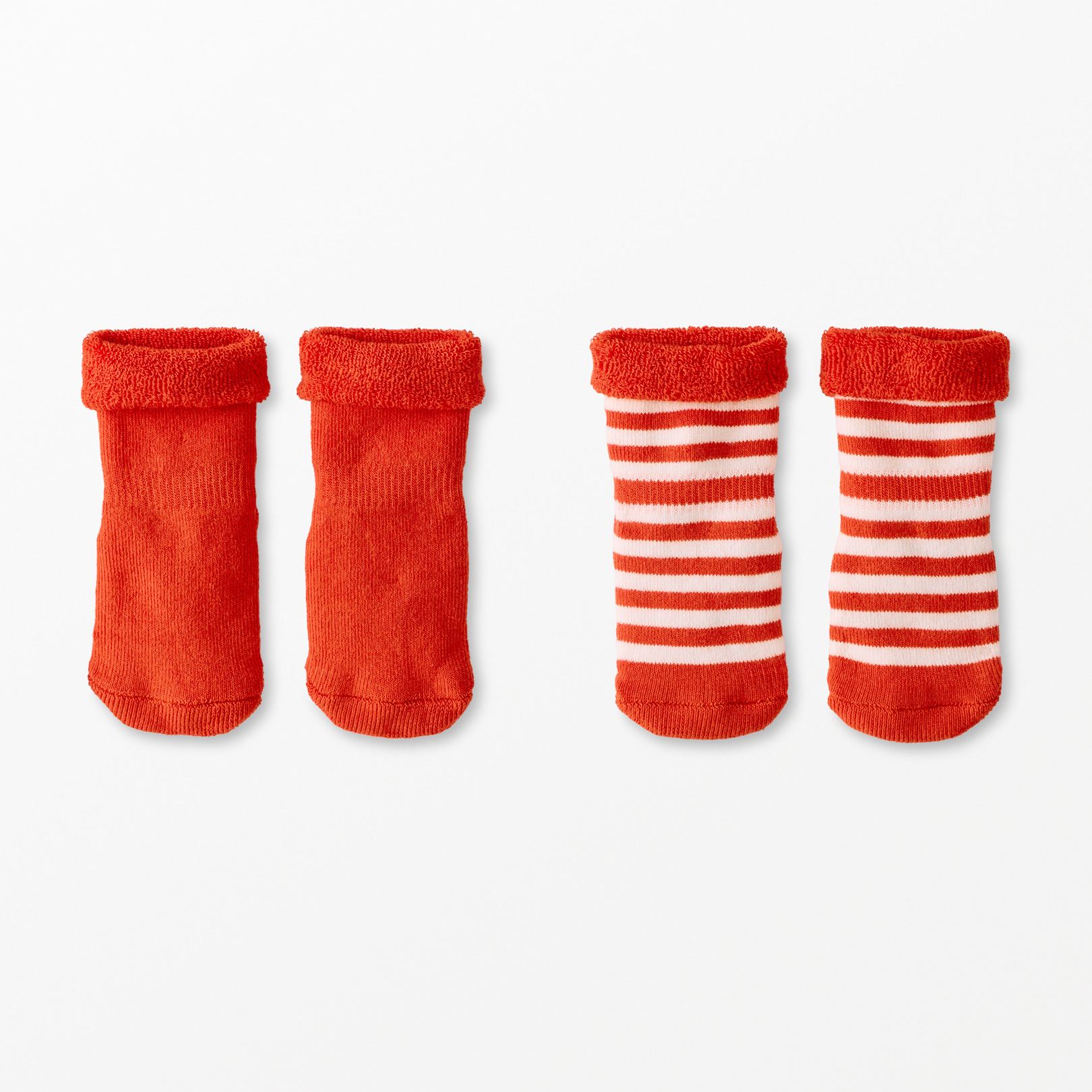 Two pairs of red baby socks with white stripes on a white background