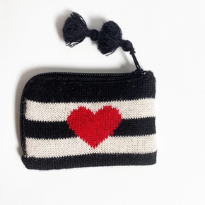 Knitted coin purse with black and white stripes and a red heart on a white background