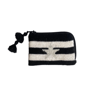 Black and white striped pouch with a tassel and star on a white background
