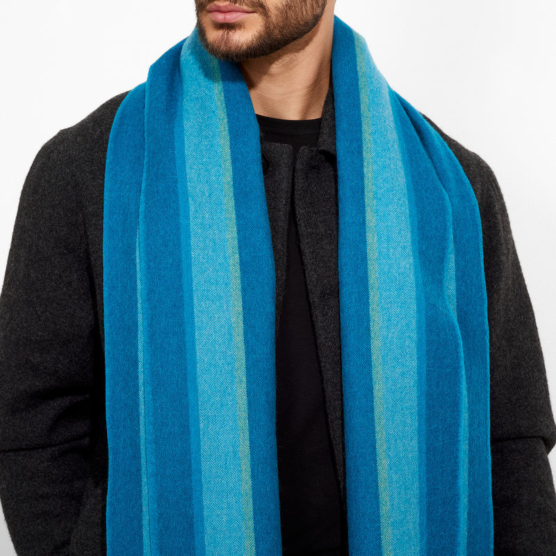 Person wearing a blue striped scarf on a white background