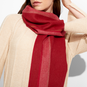 Person wearing a red scarf with a neutral background