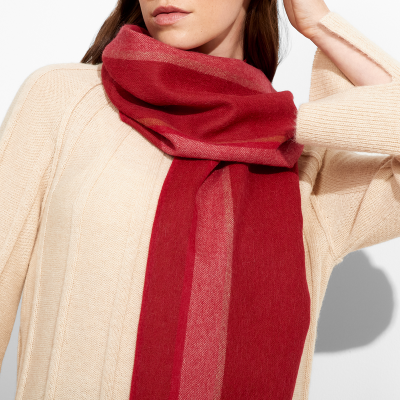 Person wearing a red scarf with a neutral background