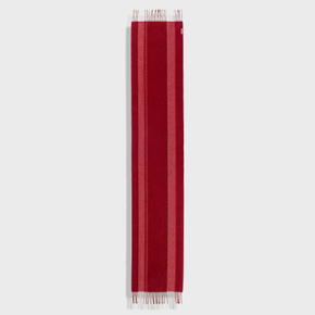 Red scarf with fringe on a light gray background
