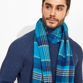 Man wearing a blue plaid scarf against a white background