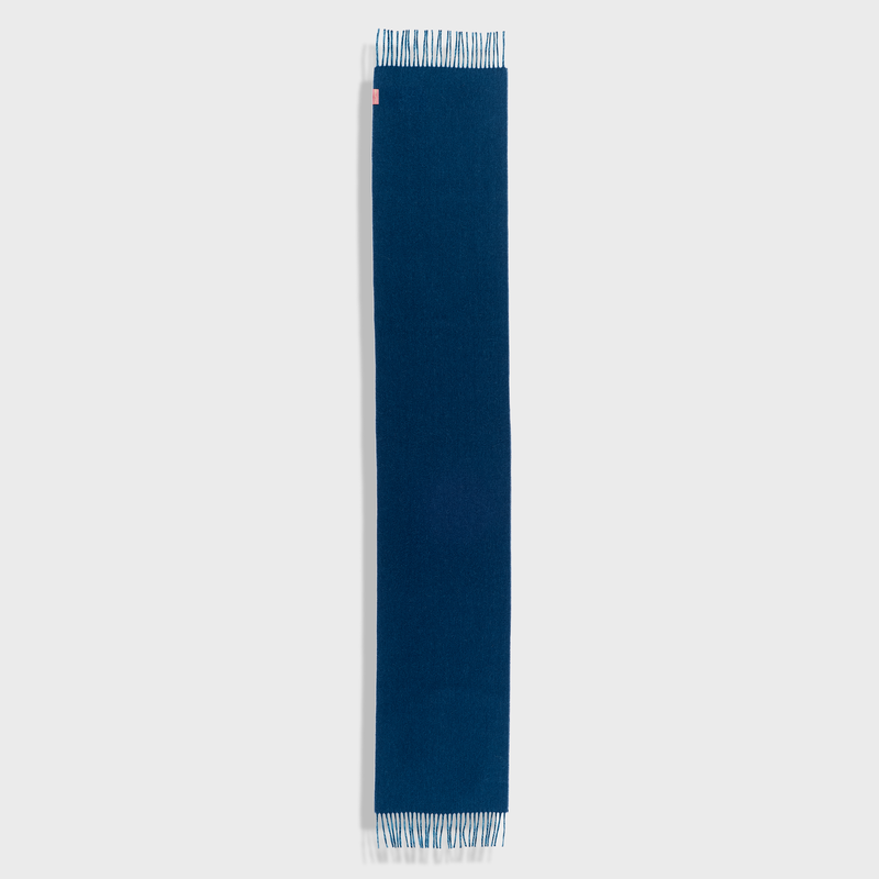 Navy blue scarf with white trim on a light gray background